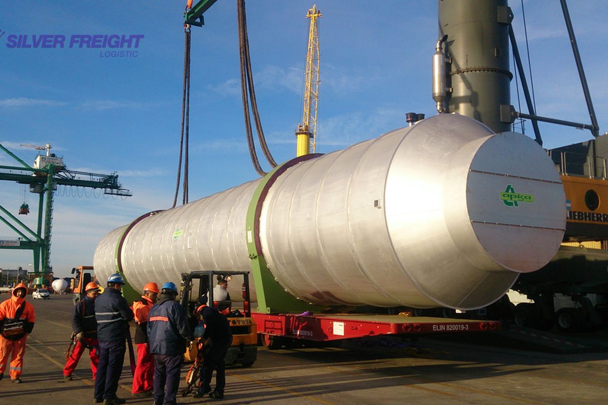Large industrial tank positioned on the quay with cranes